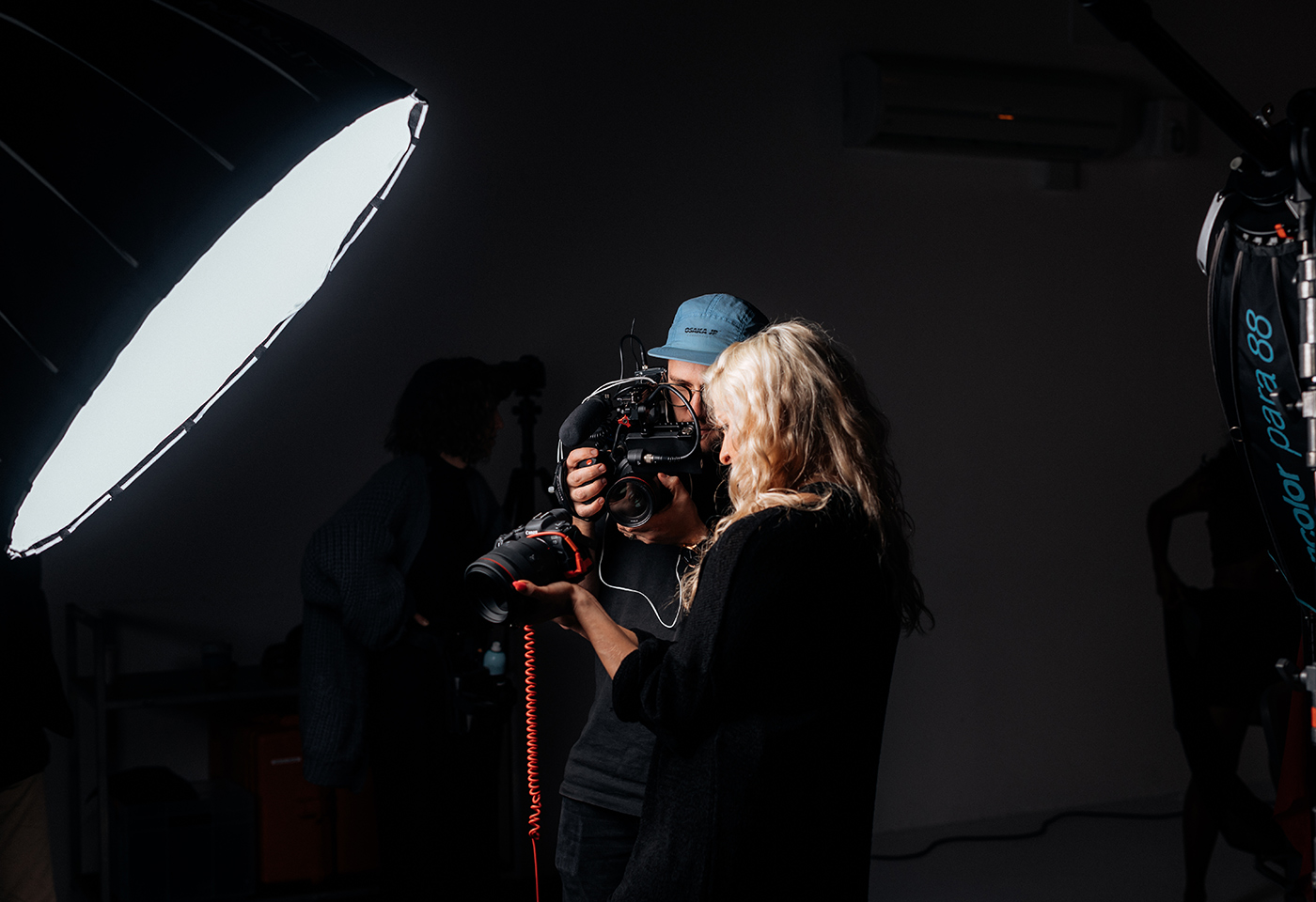 Image of photographers looking at their camera in a studio with shooting lights