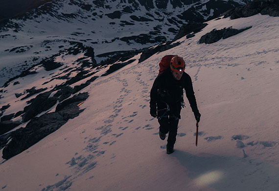 Image of Kaleb Anderson hiking on icy mountains